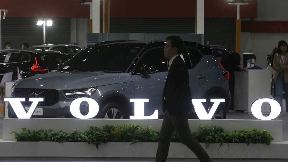epa10727606 A visitor walks past the Volvo logo at the Fast Auto Show Thailand and EV Expo 2023 trade show at BITEC in Bangkok, Thailand, 05 July 2023. The event is held between 05 and 09 July and will include displaying EV innovations such as energy storage system by Nuovo Plus, PTT EV Charger electric charging station and a simulated EV Station Pluz charging station. According to the Federation of Thai Industries, more than 16,400 new EV cars were registered in the country in March 2023.  EPA/NARONG SANGNAK