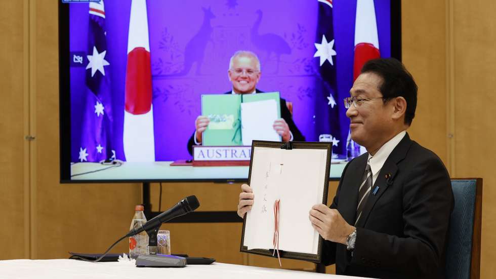 epa09668944 Japan's Prime Minister Fumio Kishida (R) and Australia's Prime Minister Scott Morrison (on video) attend a video signing ceremony of the bilateral reciprocal access agreement at Kishida's official residence in Tokyo, Japan, 06 January 2022.  EPA/ISSEI KATO / POOL