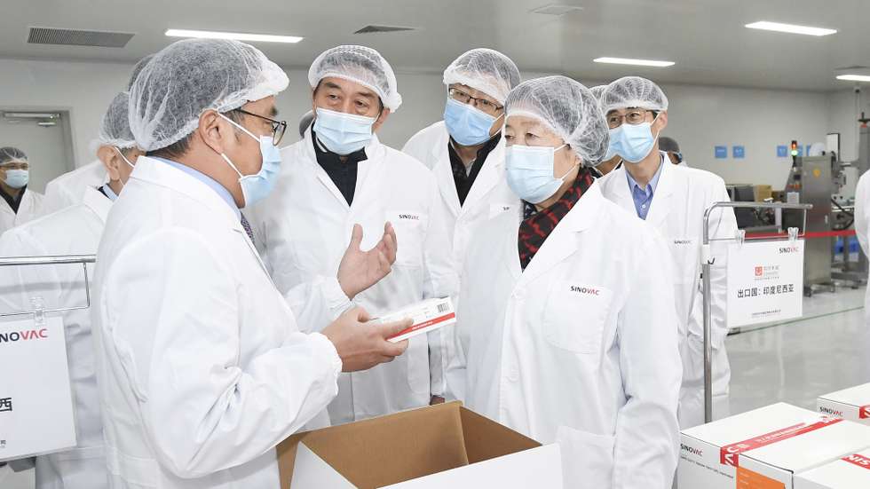 epa08861156 Chinese Vice Premier Sun Chunlan and State Councilor Wang Yong inspect the work on COVID-19 vaccine development and production at Sinovac Biotech Co., Ltd. in Beijing, China, 02 December 2020 (issued 04 December 2020). According to a scientist in charge of vaccine development in the country, China is expected to have 600 million doses of Covid-19 vaccine ready to use this year and it is set to make 'a major announcement' soon.  EPA/YAN YAN/XINHUA MANDATORY CREDIT EDITORIAL USE ONLY/NO SALES