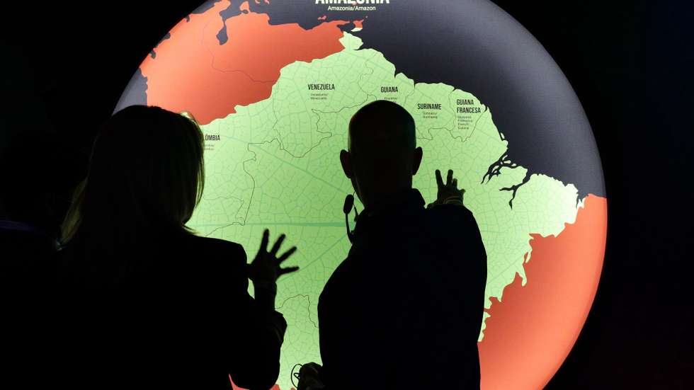 epa09646878 Visitors enjoy a tour prior to the opening of the exhibition 'Fruturos - Tempos Amazonicos' (Fruits - Amazon Times) at the Amanha Museum in Rio de Janeiro, Brazil, 16 December 2021 (issued 17 December 2021). The immensity of the Amazon, its richness, the ethnic groups that live there and their customs, are part of an exhibition in Rio de Janeiro that from 17 December on immerses the viewer in the reality of the most extensive tropical forest on the planet to highlight the urgency of its conservation. The exhibition 'Futures', which can be seen until June 2022 at the Museum of Tomorrow in Rio, brings an updated perspective of this biome and proposes new challenges to keep the forest standing.  EPA/Andre Coelho