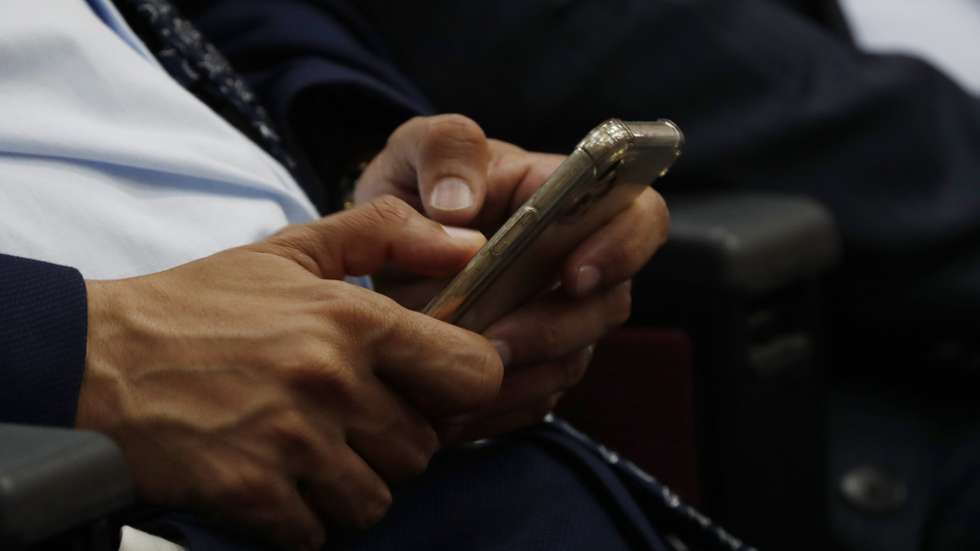 epa10633435 A Yemeni makes SMS with a smartphone on the World Telecommunication and Information Society Day, in Sana'a, Yemen, 17 May 2023. The World Telecommunication and Information Society Day (WTISD) is an annual observance that is celebrated on 17 May to raise awareness about the importance of telecommunications and the role of information and communication technologies (ICTs) in promoting social and economic development worldwide.  EPA/YAHYA ARHAB