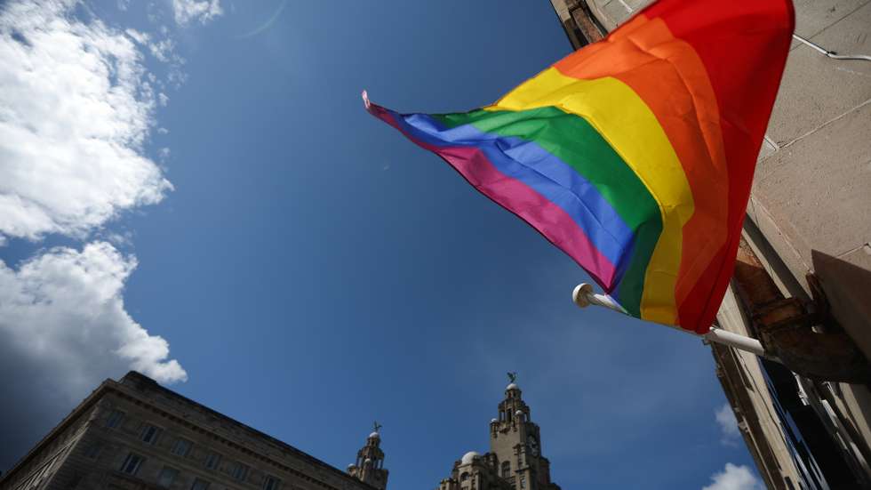 epa11499810 The Royal Liver Building behind a pride flag during the annual Pride march in Liverpool, Britain, 27 July 2024. Liverpool Pride is an annual celebration of LGBT+ culture attracting around 75,000 participants, making it one of the largest Pride event in Europe.  EPA/ADAM VAUGHAN