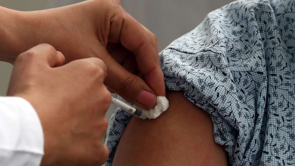 epa09071311 A Tunisian nurse inoculates a health worker against COVID-19 at a hospital in Tunis, Tunisia, at the launch of a vaccination program, 13 March 2021. Tunisia has received 30,000 doses of Russia's COVID-19 vaccine, Sputnik V. Health workers are a priority for vaccination.  EPA/MOHAMED MESSARA