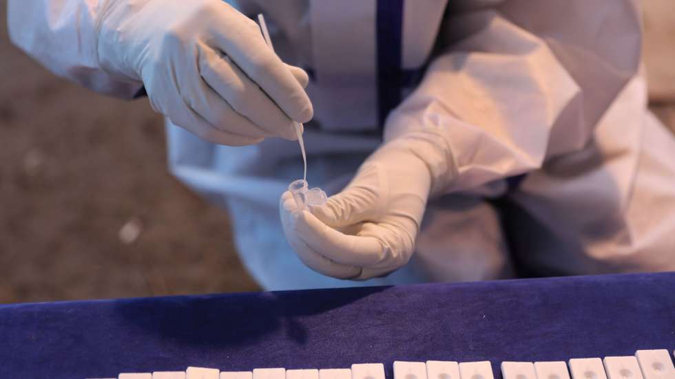 epa09146654 A health worker checks COVID-19 samples at a test center in Srinagar, the summer capital of Indian Kashmir, 20 April 2021. The Covid-19 cases continue to witness surge in Kashmir over the past three weeks. India on Monday recorded a massive surge of 273,810 fresh COVID-19 cases, the highest single-day spike in COVID-19 infections. India is seeing a second wave of the virus which has led several states including Maharashtra and the capital, New Delhi and Madhya Pradesh to impose curfew and new restrictions.  EPA/FAROOQ KHAN