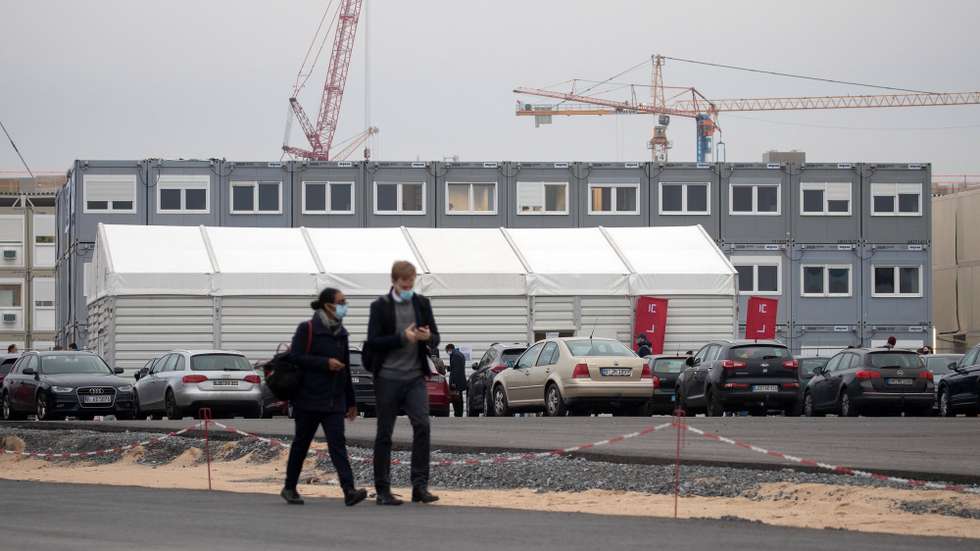 epa08803264 People wait in a line for a job interview at the site of the Tesla Gigafactory Berlin-Brandenburg in Gruenheide, Brandenburg, Germany, 06 November 2020. The CEO of the US electric vehicle company Tesla visits the site and personally interview people who are applying for engineering positions in the new factory.  EPA/HAYOUNG JEON