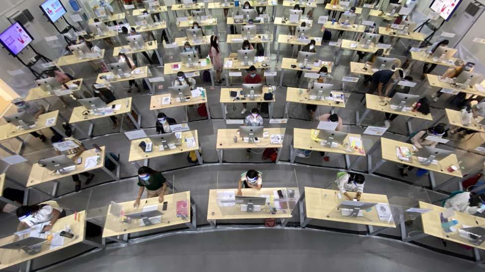 epa08746342 A view of a facility where teachers conduct online tutorials with students in need of assistance through a hotline program, in Taguig City, south of Manila, Philippines, 12 October 2020 (issued 15 October 2020). Until a Covid-19 vaccine is available, the Philippines has closed its classrooms and has imposed a model of remote learning to slow the spread of coronavirus. For thousands of families with few resources and limited or no access to the internet, 70 teachers are available to answer questions from students at a call center, which is open from Monday to Friday.  EPA/FRANCIS R. MALASIG