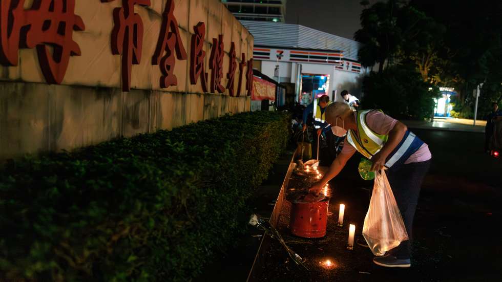 epa11716835 Workers remove flowers and candles left by mourners for the victims of a car ramming incident, at the entrance to the Zhuhai Sports Center in Zhuhai, China, 12 November 2024. According to state media, at least 35 people were killed and 43 others severely injured on the evening of 11 November after a car crashed into pedestrians in a sports center in Zhuhai, Guangdong Province. According to police, a 62-year-old suspect was being treated at a hospital after injuring himself.  EPA/ALEX PLAVEVSKI
