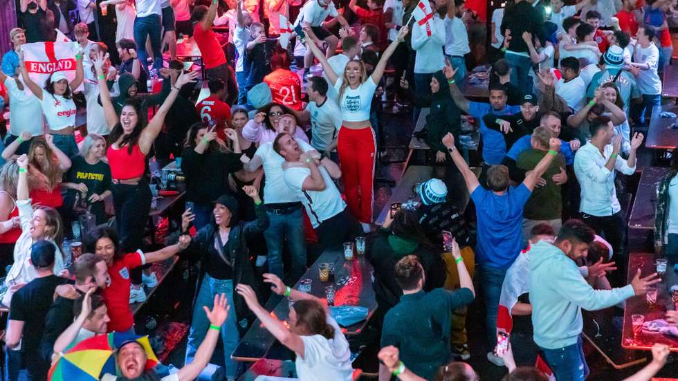 epa09330594 England supporters celebrate England reaching the final after watching a public viewing of the UEFA EURO 2020 semi final soccer match between England and Denmark, in Boxpark, Croydon, London, Britain, 07 July 2021.  EPA/VICKIE FLORES