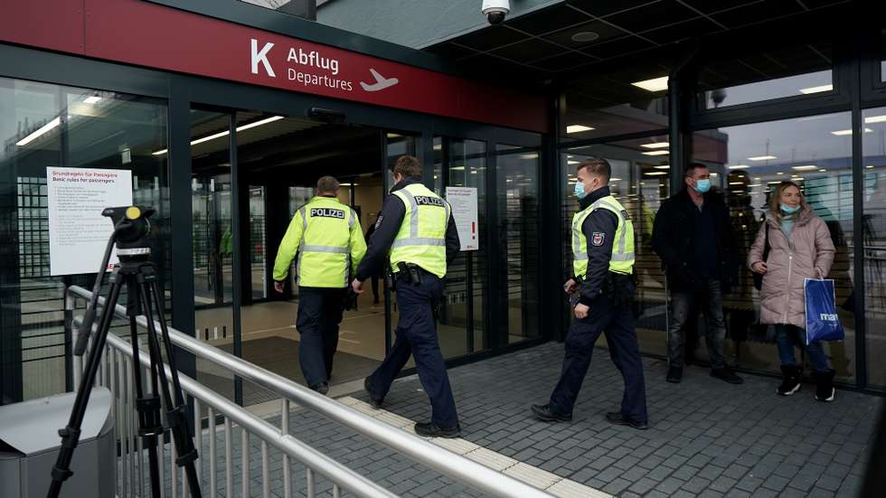 epa08943308 Police officers enter the Terminal 5 of the Berlin Brandenburg International Airport BER in Schoenefeld, Germany, 17 January 2021. Navalny plans to return to Russia on a scheduled flight to Moscow later in the afternoon on 17 January. He was treated at the Charite hospital in Berlin since 22 August 2020 for being poisoned with a nerve agent from the Novichok group and was discharged from acute inpatient care on 22 September 2020.  EPA/ALEXANDER BECHER