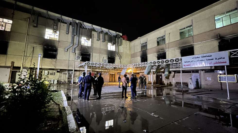 epa09157835 Firefighters gather outside Ibn Al-Khatib Hospital in the aftermath of a fire, south of Baghdad, Iraq, 25 April 2021. At least 27 people died and dozens were injured when a fire broke out following the explosion of oxygen tanks at the hospital equipped to treat COVID-19 patients on 24 April.  EPA/MURTAJA LATEEF