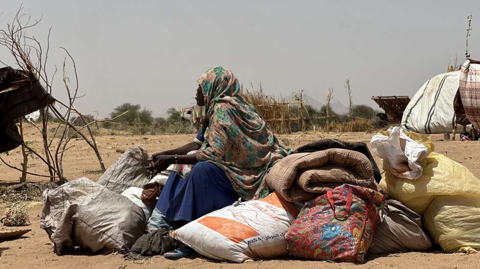 epa12049103 A Sudanese woman, who fled from the internally displaced persons (IDP) Zamzam camp, rests while on her way to the Tawila Camps amid the ongoing conflict between Sudan's army and the Rapid Support Forces (RSF), in North Darfur, Sudan, 23 April 2025. The RSF claimed control of the Zamzam camp after its assault in April 2025. According to the UNHCR, over four million people have fled Sudan to neighboring countries since the outbreak of the armed conflict in April 2023.  EPA/MARWAN MOHAMED