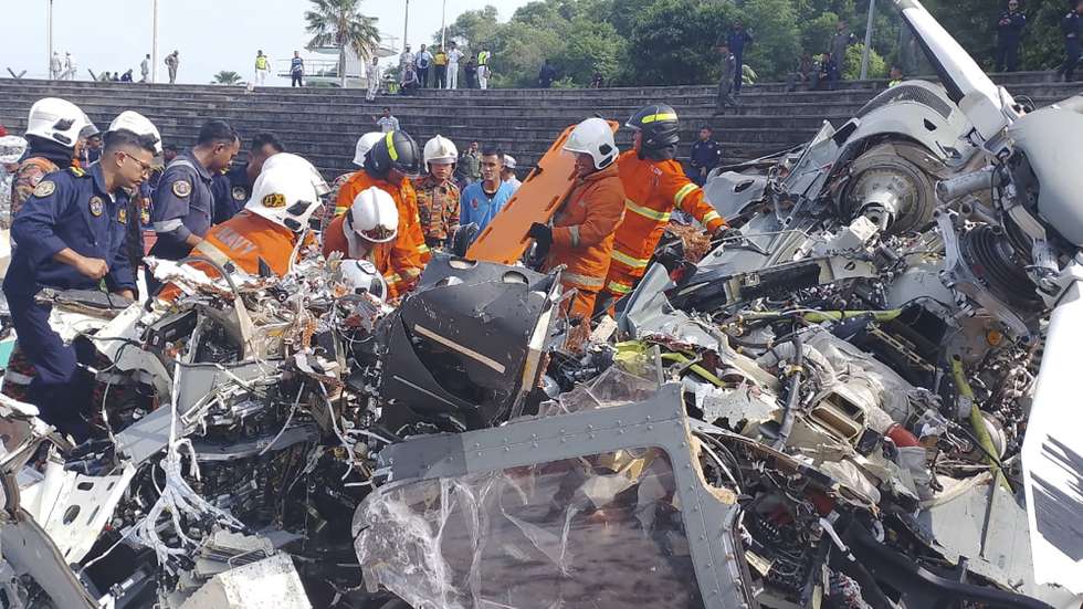 epa11295049 A handout photo made available by Perak's Fire and Rescue Department shows Fire and Rescue Department of Malaysia officers at the scene where two helicopters crashed during a rehearsal, at the Royal Malaysian Navy base in Lumut, Perak state, Malaysia, 23 April 2024. 'Ten people were killed after two helicopters collided in mid-air during a rehearsal for a Royal Malaysian Navy (TLDM) parade,' the Royal Malaysian Navy said in a statement.  EPA/Perak's Fire and Rescue Department / HANDOUT   HANDOUT EDITORIAL USE ONLY/NO SALES HANDOUT EDITORIAL USE ONLY/NO SALES