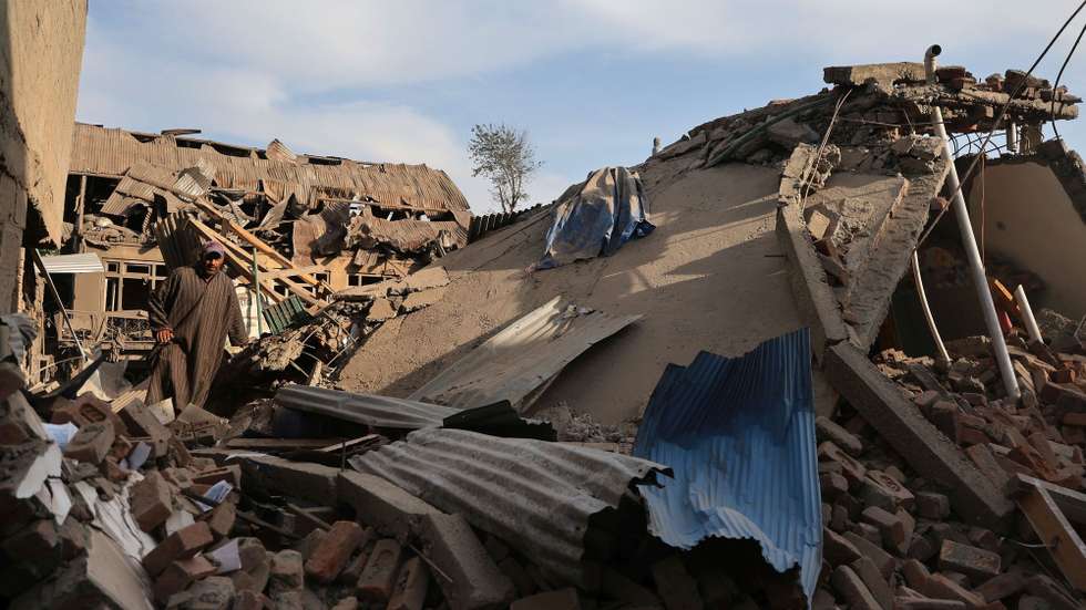 epa12055639 Villagers walk in the debris of demolished houses related to the family of Ahsan Ul Haq Sheikh, who officials say was involved in the Pahalgam attack, in Murran village of Pulwama, south of Srinagar, India, 26 April 2025. The houses of two more militants were destroyed. At least 26 people were killed on 22 April when gunmen opened fire on a group of tourists in Pahalgam, in what officials described as the most serious civilian attack in the region in recent years.  EPA/FAROOQ KHAN