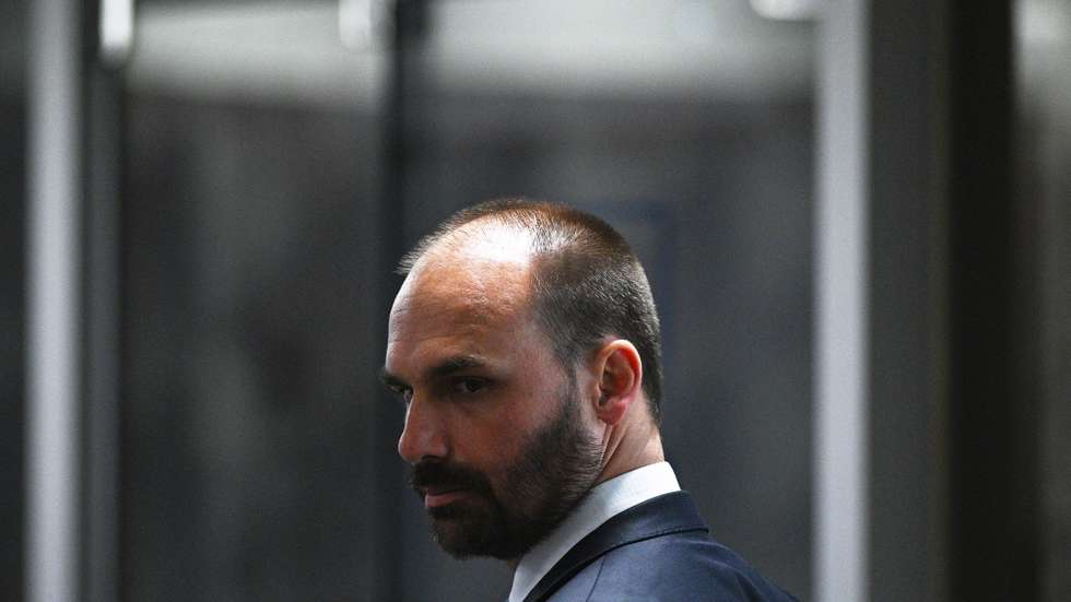 epa10804845 Deputy Eduardo Bolsonaro, son of former Brazilian president Jair Bolsonaro, participates in the statement session of computer expert Walter Delgatti before the Mixed Parliamentary Commission of Investigation (CPMI) on the anti-democratic acts of 08 January 2023 against the Federal Senate, in Brasilia, Brazil, 17 August 2023. Walter Delgatti who worked for a far-right deputy confessed that former Brazilian president Jair Bolsonaro (2019-2022) suggested he invade the National Council of Justice systems in order to demonstrate the supposed fragility of the voting system for the elections of the year past. Delgatti said the far-right ex-president even promised him 'a pardon' in case he was found out.  EPA/Andre Borges