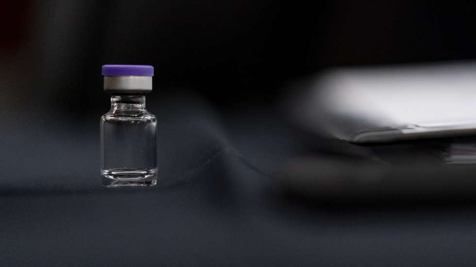 epa08875017 An example of the Pfizer COVID-19 vaccine vial is visible on a desk before a Senate Transportation subcommittee hybrid hearing on transporting ​a coronavirus vaccine on Capitol Hill in Washington, DC, USA, 10 December 2020.  EPA/ANDREW HARNIK / POOL Pool Image