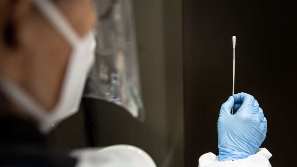 epa08897464 A health worker conducts a rapid coronavirus disease (COVID-19) test on a swab sample, in Bologna, northern Italy, 21 December 2020. Starting from 21 December, rapid tests (free of charge for teachers, students and school staff), which give a result in about 15 minutes, will be available in pharmacies as part of a second screening campaign, always voluntary and free, wanted by the Emilia-Romagna Region to strengthen the fight against the coronavirus pandemic, media reported.  EPA/MAX CAVALLARI