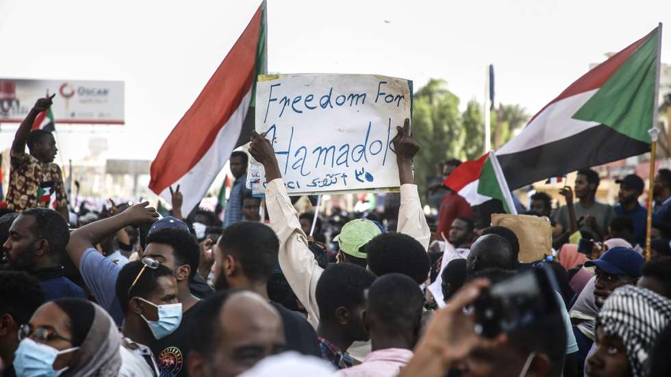 epa09554647 Thousands of people shout slogans and hold national flags during anti-coup protests as a part of nationwide demonstrations after miltary took over the government on 25 October, in the capital Khartoum, Sudan, 30 October 2021. Sudan's military launched a coup attempt on 25 October and arrested the Prime Minister and other senior ministers and civilian members of the Transitional Sovereignty Council during early morning raids.  EPA/STR
