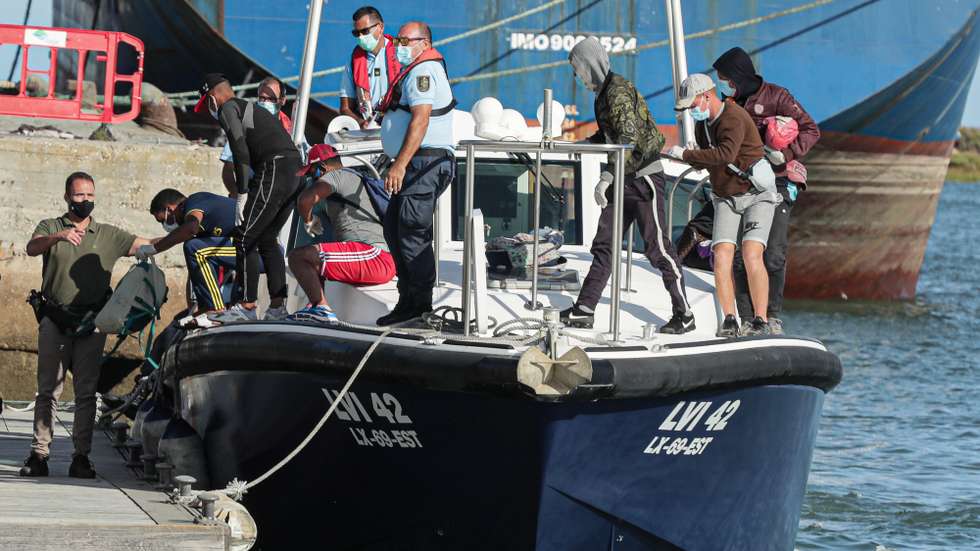 epa08671342 Authorities intercepted a group of migrants who disembarked illegally on the Desert Island in Faro, Portugal, 15 September 2020. According to the commander of the Southern Maritime Zone, the group of 28 migrants, allegedly from Morocco that includes three women, was at 4:30 p.m. 'in transit to the commercial wharf of Faro on board vessels of the Maritime Police and Republican National Guard.  EPA/LUIS FORRA