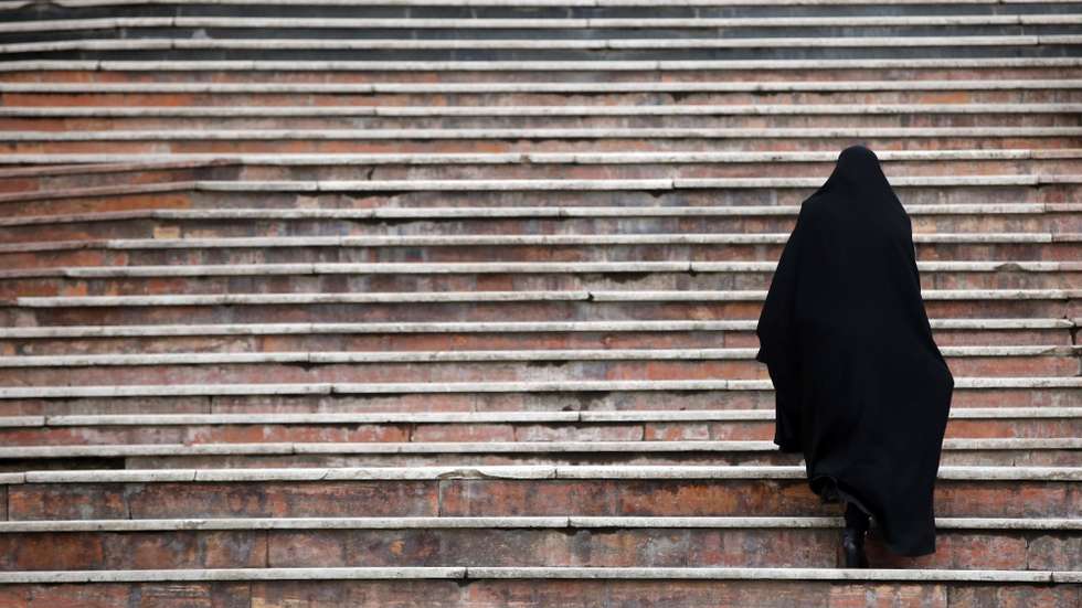 epa09067717 An Iranian woman wearing Islamic black gown (Chador) walks at a park in Tehran, Iran, 11 March 2021. According to ISAN news agency, 150,000 doses of Indian COVID-19 vaccine has arrived to the country on 11 March as President Hassan Rouhani was quoted as saying that three kind of Iranian local-made vaccines will be ready soon in summer. Iran has got some COVID-19 vaccine from Russia, China, and India as the country is far from massive vaccination yet.  EPA/ABEDIN TAHERKENAREH