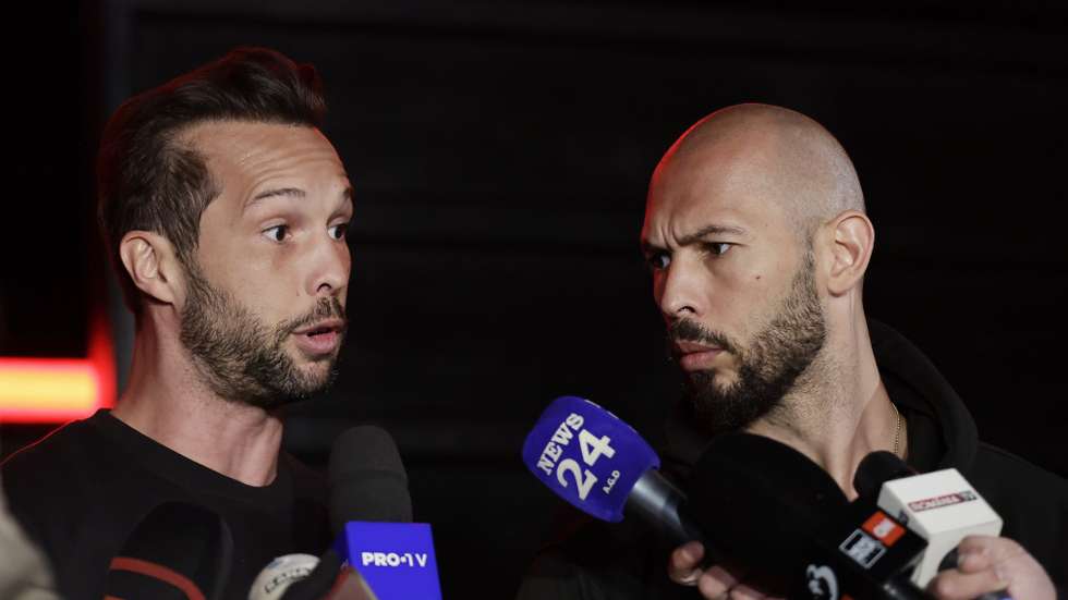 epa11980130 Former professional kickboxer and social media influencer Andrew Tate (R), accompanied by his brother Tristan (L), speaks with TV reporters after returning from a trip in the United States, in front of their property, in Bucharest, Romania, early 22 March 2025. After spending weeks in the USA, Tate brothers returned to Romania, where they face legal charges. Andrew Tate and his brother Tristan were arrested on 29 December 2022 as a result of the DIICOT (Directorate for Investigating Organized Crime and Terrorism) inquiry on charges of human trafficking and intention to form an organized crime group. Romanian police allege that the two brothers and their associates coerced victims for creating a paid pornography service for social media platforms. The trial itself has not started yet, as the appeal court judges sent the case back to DIICOT prosecutors by a decision made at the end of 2024.  EPA/Robert Ghement
