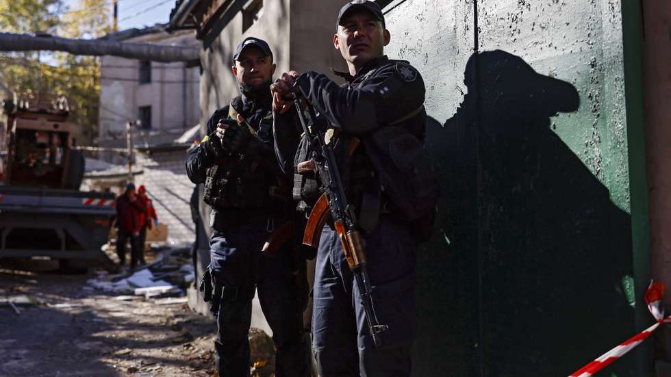 epa10278771 Policemen secure damaged buildings in Mykolaiv, Ukraine, 01 November 2022. Four missiles hit the city area the night before. Russian troops on 24 February entered Ukrainian territory, starting a conflict that has provoked destruction and a humanitarian crisis.  EPA/HANNIBAL HANSCHKE