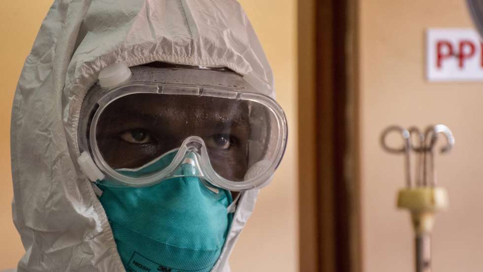 epa10255232 A Ugandan doctor dressing in his Personal Protective Equipments at the Entebbe Regional Referral Hospital Isolation Centre in Entebbe, Uganda, 20 october 2022. A total of 64 positive cases and 24 deaths have so far been confirmed in Uganda since the outbreak of the deadly Ebola virus a month ago in Uganda.  EPA/ISAAC KASAMANI