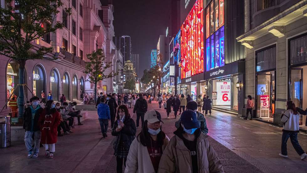 epa08908147 People walk in a shopping street in Wuhan, China, 28 December 2020. Life in Wuhan, a Chinese city of more than 11 million, which nearly a year ago became the epicenter of the coronavirus outbreak is returning to normal. Since May the capital of Hubei province has not recorded locally-transmitted cases of Covid-19.  EPA/ROMAN PILIPEY