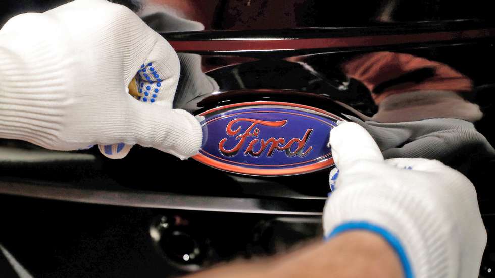 epa08957143 (FILE) - A worker attaches the Ford logo to a Fiesta car at the US car manufacturer plant Ford in Cologne, Germany, 18 January 2019 (reissued 22 January 2021). Ford on 21 January 2021 said it would recall up to three million automobiles of various models amid safety concerns related to airbag inflators.  EPA/FRIEDEMANN VOGEL *** Local Caption *** 54928264