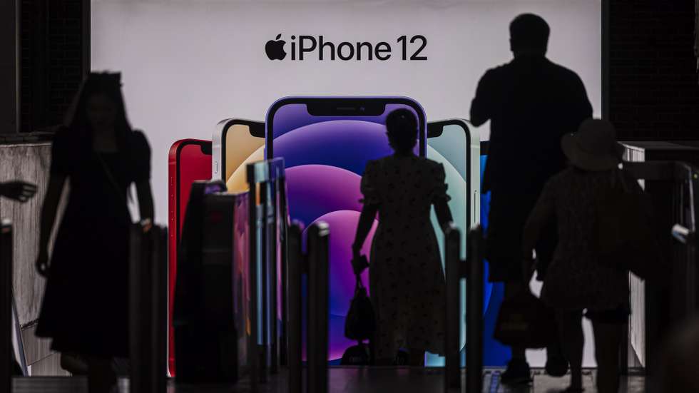 epa09332899 People enter the subway in front of a Apple's iPhone 12 advertisement, in Shanghai, China, 09 July 2021. According to the National Bureau of Statistics, China's Consumer Price Index (CPI), which is a main gauge of inflation, rose 1.1 percent year-on-year in June.  EPA/ALEX PLAVEVSKI