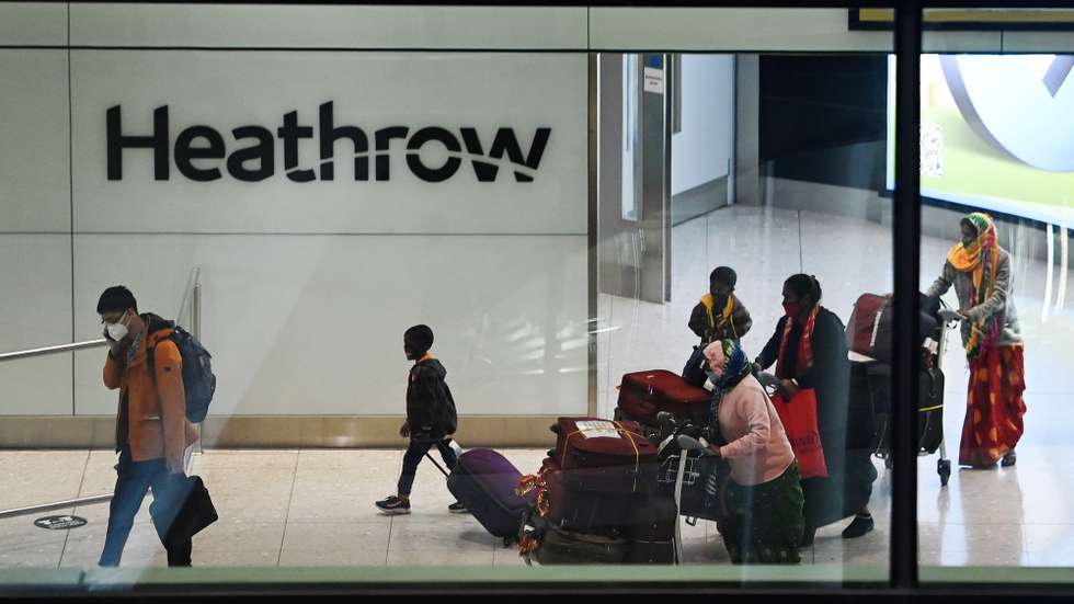 epa08989117 Travellers arrive at Heathrow Airport in London, Britain, 05 February 2021. The UK government is set to implement stricter measures for travellers arriving at Heathrow from Monday 15 February 2021. People arriving into Heathrow from so called 'at risk' countries will have to isolate in designated government hotels for up to ten days at their own cost.  EPA/ANDY RAIN
