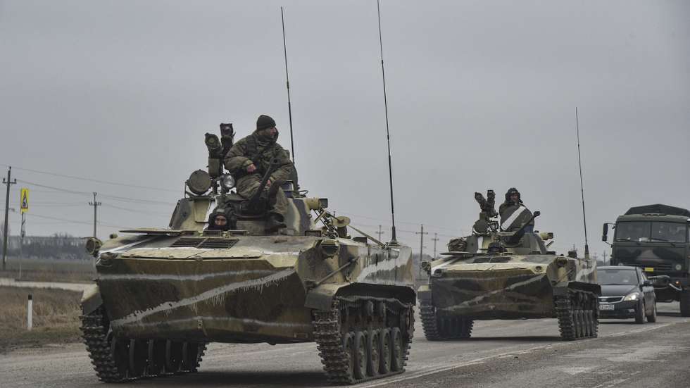 epa09784384 Russian soldiers on the amphibious infantry fighting vehicle BMP-2 move towards mainland Ukraine on the road near Armiansk, Crimea, 25 February 2022. Russian troops entered Ukraine on 24 February prompting the country's president to declare martial law and triggering a series of announcements by Western countries to impose severe economic sanctions on Russia.  EPA/STRINGER