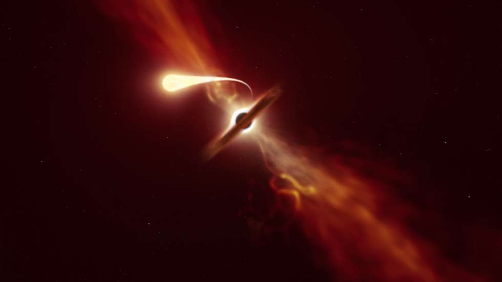 epa08737588 A handout photo made available by the European Southern Observatory (ESO) shows an illustration that depicts a star (in the foreground) experiencing spaghettification as it is sucked in by a supermassive black hole (in the background) during a 'tidal disruption event' (issued 09 October 2020). In a new study, done with the help of ESO's Very Large Telescope and ESO's New Technology Telescope, a team of astronomers found that when a black hole devours a star, it can launch a powerful blast of material outwards.  EPA/ESO/M. Kornmesser / HANDOUT  HANDOUT EDITORIAL USE ONLY/NO SALES