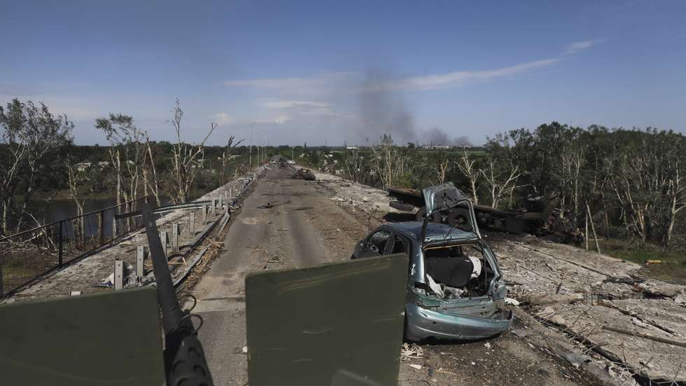 epa09992806 Ukrainian servicemen drive an APC on a damaged road near the front line in the city of Severodonetsk, Luhansk region, Ukraine, 02 June 2022, where heavy fighting took place in the last few days. While addressing the Luxembourg parliament, Ukrainian President Volodymyr Zelensky said that as of 02 June, about 20 percent of Ukraine is under the control of Russia. Russian troops on 24 February entered Ukrainian territory, starting a conflict that has provoked destruction and a humanitarian crisis.  EPA/STR