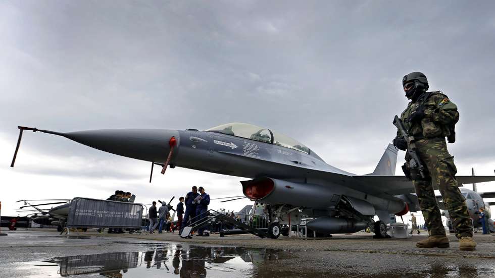 epa06744834 A Romanian masked member of airborne special forces guards an F16 jet fighter belonging to Romanian Air Force during the Black Sea Defense &amp; Aerospace Exhibition 2018 (BSDA), held in Bucharest, Romania, 17 May 2018. More than 270 companies from the fields of defense, security and aerospace have displayed products and equipment at Black Sea Defense &amp; Aerospace 2018, one of the largest defense bi-annual exhibition held in Eastern Europe.  EPA/ROBERT GHEMENT