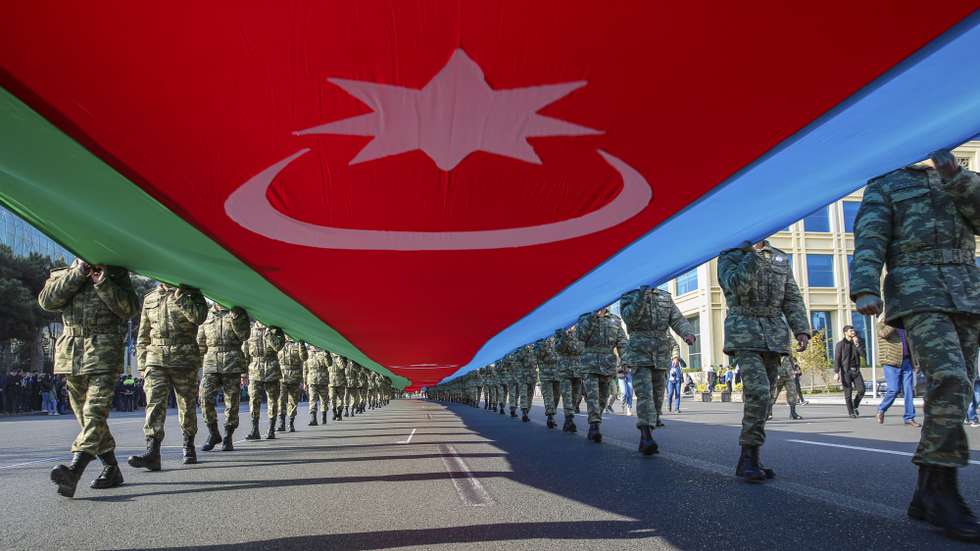 epa09571061 Azeri soldiers carry a large-scale national flag on the anniversary of the end of the 2020 war over the Nagorno-Karabakh region between Azerbaijan and Armenia, in downtown Baku, Azerbaijan, 08 November 2021. On 10 November 2020, a joint statement was published by the President of Azerbaijan, the Prime Minister of Armenia and the President of Russia on the complete cessation of all hostilities in the zone of the Nagorno-Karabakh conflict from 00:00 Moscow time.  As a result of the war, Baku regained a number of territories lost in the early 1990s. According to information disseminated by the Azerbaijani Ministry of Defense, some 2,783 Armed Forces servicemen were killed in the armed conflict.  EPA/ROMAN ISMAYILOV