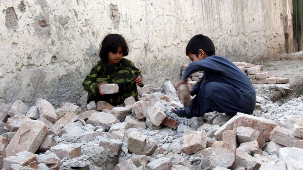 epa03675218 Afghan children search the debris of their house that was collapsed in an earthquake in Nangarhar, where an earthquake had struck in Afghanistan, 24 April 2013. At least seven people were killed and more than 80 injured on 24 April after a 5.6-magnitude earthquake struck Afghanistan. Last week, at least 30 people were killed and more than 200 injured in Pakistan's remote south-western border region after a magnitude-7.8 earthquake struck neighboring Iran.  EPA/ABDUL MUEED