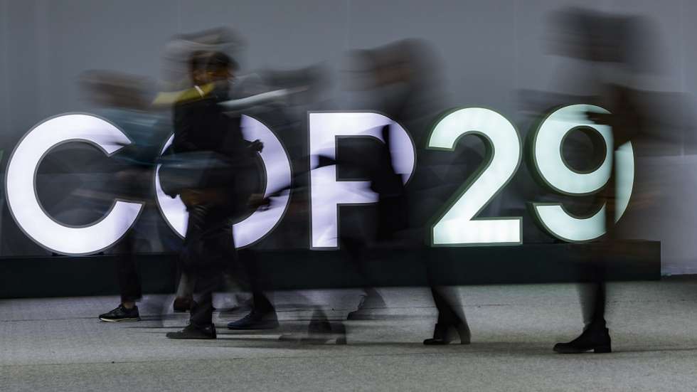 epa11730467 Participants pass light letters at the United Nations Climate Change Conference COP29 in Baku, Azerbaijan, 20 November 2024. The Azerbaijani capital of Baku hosts the 2024 United Nations Climate Change Conference (COP29) from 11 to 22 November 2024.  EPA/ANATOLY MALTSEV