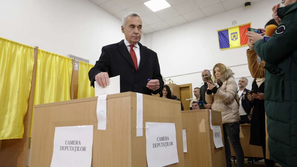 epa11750813 Romanian far-right independent runoff candidate Calin Georgescu (L) casts his ballot for the parliamentary elections at a polling station in Secondary School No. 1 in Mogosoaia village, near Bucharest, Romania, 01 December 2024. Approximately 18 million Romanian citizens are expected at the polling stations this weekend for choosing the bicameral parliament members, according to the Permanent Electoral Authority (AEP), of which 989,230 people can express their intention abroad. Calin Georgescu led in the first round of the presidential race, winning 22.94 percent of the total number of votes, followed by Elena Lasconi, leader of the USR (Save Romania Union), with 19.18 percent. The second round of Romania's presidential election will be held on 08 December 2024.  EPA/ROBERT GHEMENT