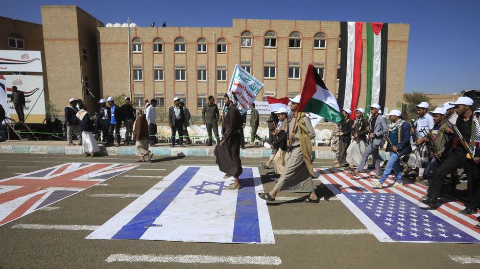 epa11170086 Newly recruited university students march on US, Israeli and UK flags on the ground during a protest against US-led strikes on Houthi positions, at Sana'a University, in Sana'a, Yemen, 21 February 2024. Yemen's Houthis have been mobilizing and recruiting thousands of militiamen and university students as part of the creation of an army as the Shiite group prepares for a possible confrontation with the United States, Britain and Israel amid the escalation of Houthi attacks on shipping lanes in the Red Sea and the Gulf of Aden. The US-led coalition continues to strike Houthi targets in war-torn Yemen as it seeks to degrade the Houthis' abilities to attack commercial shipping vessels amid high tensions in the Middle East. The US designation of Yemen's Houthis as a 'Specially Designated Global Terrorist group' came into effect on 16 February, due to their increased attacks on shipping lanes since November 2023. The US Department of Defense announced in December 2023 a multinational operation to safeguard trade and protect ships in the Red Sea in response to the escalation of Houthi attacks.  EPA/YAHYA ARHAB