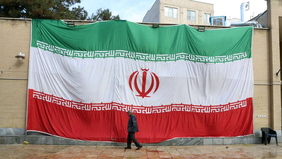 epa12667188 A huge Iranian national flag hangs from the wall of a mosque which was damaged by fire during recent anti-government protests, in Tehran, Iran, 21 January 2026. Iran is experiencing a nationwide internet blackout that began on 08 January 2026, amid an intensifying wave of anti-government protests.  EPA/ABEDIN TAHERKENAREH
