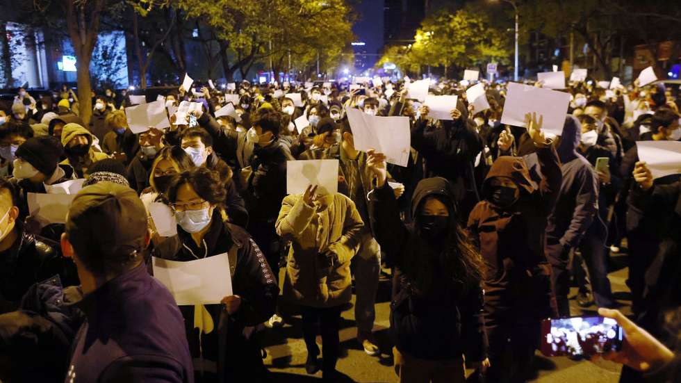 epaselect epa10332665 Protesters hold blank white pieces of paper during a protest triggered by a fire in Urumqi that killed 10 people in Beijing, China, 27 November 2022. Protests against’s China strict Covid restrictions have erupted in various cities including Beijing and Shanghai, triggered by a tower fire that killed 10 people Xinjiang’s capital, Urumqi.  EPA/MARK R. CRISTINO