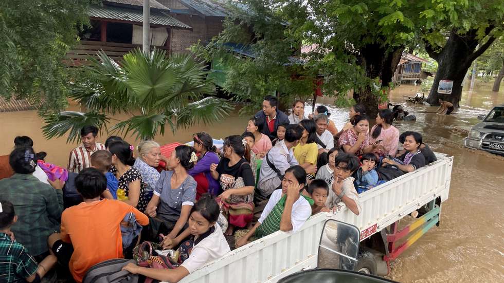 epa11601520 Flood victims evacuate the area on a truck in Pyinmana, Naypyidaw, Myanmar, 13 September 2024. Heavy rains triggered by Typhoon Yagi have caused severe flooding in parts of Myanmar, leaving thousands stranded in their homes, with further heavy rainfall and thunderstorms expected, according to the state weather office.  EPA/NYEIN CHAN NAING