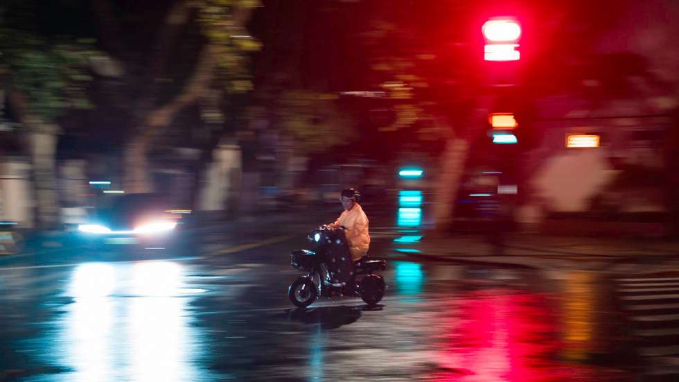 epa11606417 A person rides a scooter on a street during heavy rain amid Typhoon Bebinca in Shanghai, China, 16 September 2024. Shanghai, China&#039;s financial hub, has closed its seaports and canceled over 600 flights in preparation for Typhoon Bebinca, expected to be the strongest tropical storm to hit the city in 75 years. More than 377,000 people were evacuated, and the Mid-Autumn Festival&#039;s mood has been dampened by the potential for up to 10 inches of rain.  EPA/ALEX PLAVEVSKI