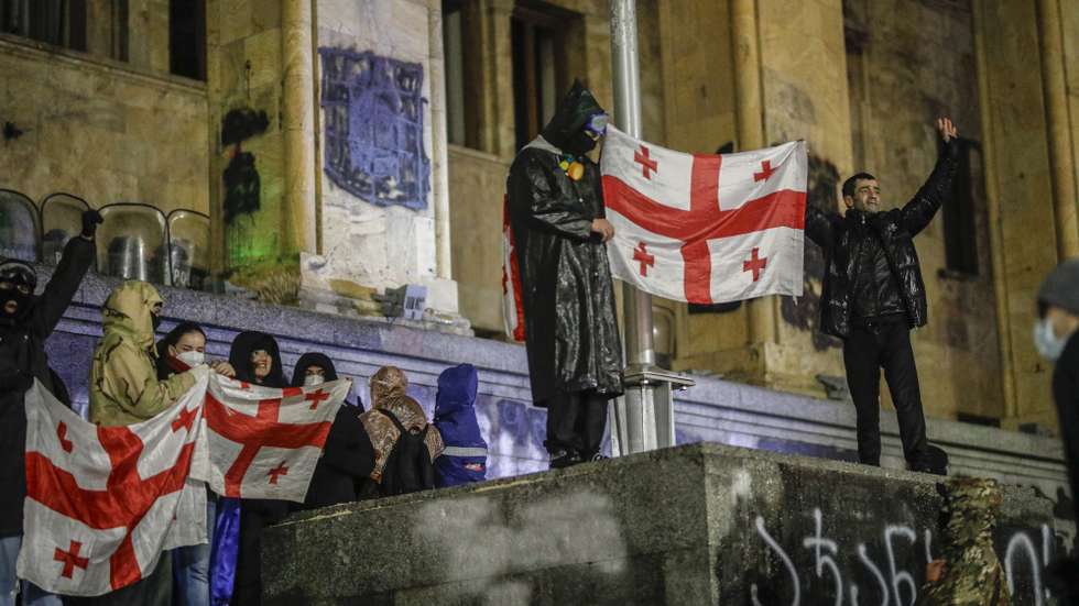 epa11752437 Georgian opposition supporters hold Georgian flags during a protest in front of the Parliament building in Tbilisi, Georgia, 01 December 2024. Thousands of pro-EU activists demonstrated in the Georgian capital of Tbilisi to protest against the country's ruling party decision to suspend accession talks with the European Union (EU) until the end of 2028.  EPA/DAVID MDZINARISHVILI
