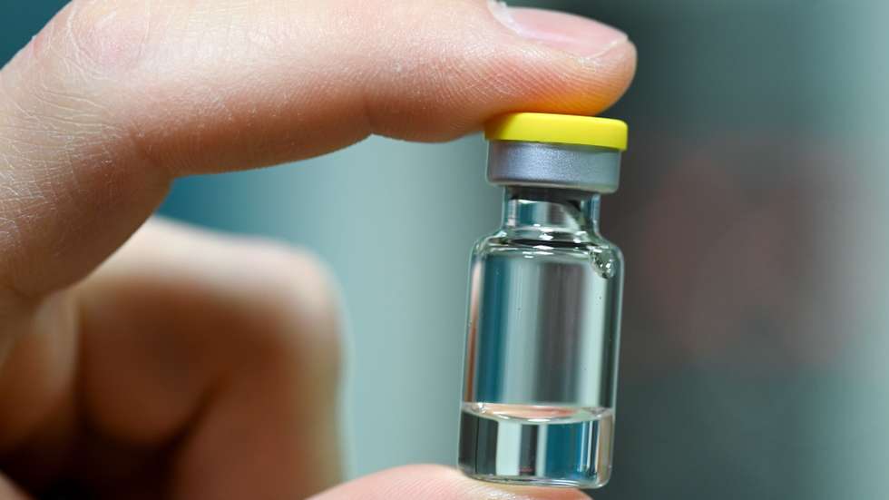 epa08837600 An employee holds an ampoule into which the vaccine is later filled at the vaccine manufacturer IDT Biologika's plant in Dessau-Rosslau, Germany, 23 November 2020. German Health Minister Jens Spahn announced the planned purchase of five million coronavirus vaccine doses. According to the scientific director, IDT expects to go into commercial production of the coronavirus vaccine in the middle of next year.  EPA/HENDRIK SCHMIDT / POOL