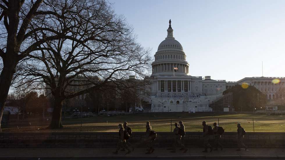 epa08925022 Members of the District of Columbia National Guard walk past the grounds of the US Capitol in Washington, DC, USA, 07 January 2021. Members of Congress certified the 2020 Electoral College early this morning following more than 6 hours of suspension on Wednesday as a result of  supporters of US President Donald J. Trump storming into the US Capitol following a rally with the President on the National Mall.  EPA/JUSTIN LANE