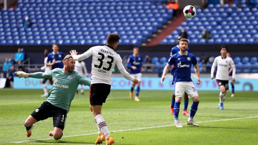 epa09201727 Andre Silva of Eintracht Frankfurt scores their side's first goal during the Bundesliga match between FC Schalke 04 and Eintracht Frankfurt at Veltins-Arena on May 15, 2021 in Gelsenkirchen, Germany, 15 May 2021.  EPA/LARS BARON / POOL DFL regulations prohibit any use of photographs as image sequences and/or quasi-video.