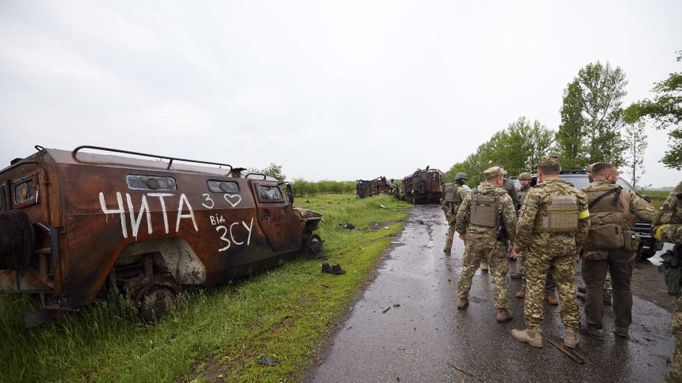 epa09984301 A handout photo made available by the Ukrainian Presidential Press Service shows burned Russian vehicles during a visit by Ukrainian President Volodymyr Zelensky (obscured) to the Kharkiv region, Ukraine, 29 May 2022, amid the Russian invasion. According to the Ukrainian presidential office, Zelensky visited the frontline positions in the east of the country and presented state awards to the military during a working trip to the Kharkiv region. On 24 February, Russian troops invaded Ukrainian territory starting a conflict that has provoked destruction and a humanitarian crisis.  EPA/UKRAINIAN PRESIDENTIAL PRESS SERVICE HANDOUT -- MANDATORY CREDIT: UKRAINIAN PRESIDENTIAL PRESS SERVICE -- HANDOUT EDITORIAL USE ONLY/NO SALES