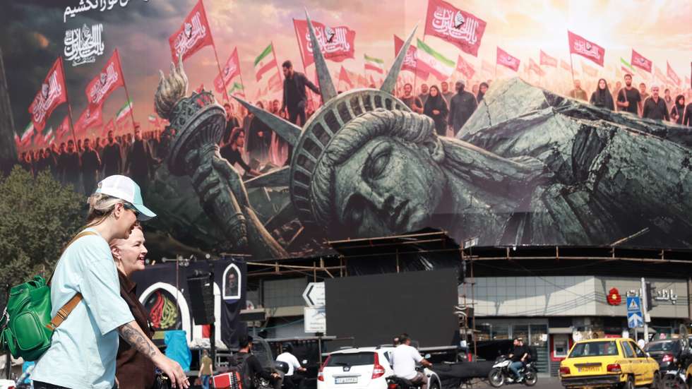epa13157692 People walk past an anti-US billboard at Enghelab Square in central Tehran, Iran, 09 August 2026. The Iranian Foreign Ministry stated the agreement with Oman would not imply reopening the Strait of Hormuz without the United States accepting the Iranian proposals.  EPA/ABEDIN TAHERKENAREH RESTRICTIONS: NO Access Israel Media/Persian Language TV Stations Outside Iran/Strictly No Access BBC Persian/VOA Persian/Manoto TV/Iran International TV. (As mandated by Iran's Directorate General for Foreign Media) -- ISRAEL OUT --