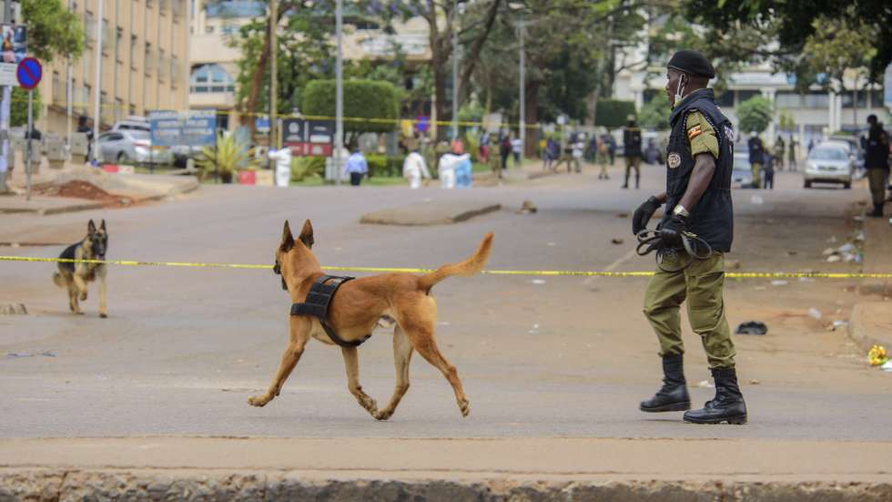 epa09585102 Ugandan police work on the scene of a bomb blast near the Central Police Station in Kampala, Uganda, 16 November 2021. According to Ugandan Police, two blasts occurred near the Central Police Station and another near Parliament in the capital Kampala. No one has claimed responsibility for the attacks in which several were reportedly injured.  EPA/NICHOLAS BAMULANZEKI